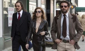 American Hustle: Christian Bale, Amy Adams and Bradley Cooper walking in street