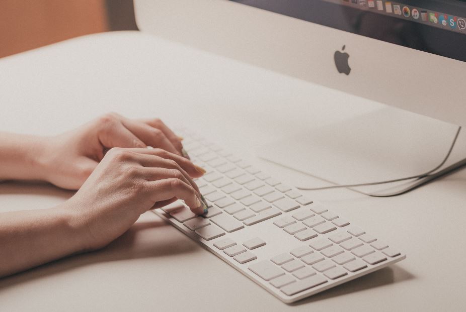 fingers writing on a keyboard